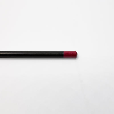 A black pencil with a red eraser end, reminiscent of Espoir Studios' RED LIP LINER PREDRAW PENCIL, lies horizontally on a plain white surface.