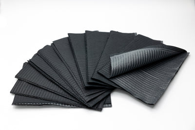 A stack of Espoir Studios' DISPOSABLE DENTAL BIBS (125 pieces), commonly used for Surgical Grade Dental Bibs and PMU procedures, set against a clean white background.