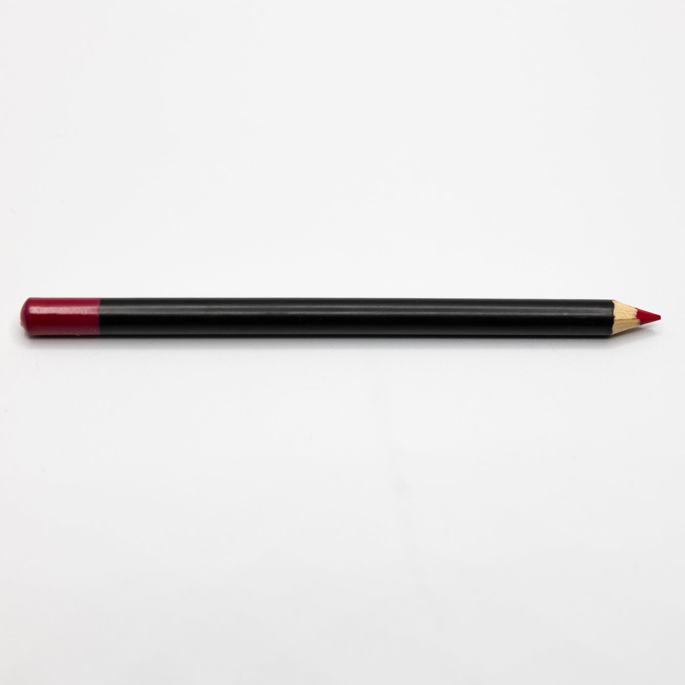 A red-tipped black-colored pencil, reminiscent of elegant Espoir Studios RED LIP LINER PREDRAW PENCIL, lies horizontally on a plain white background.